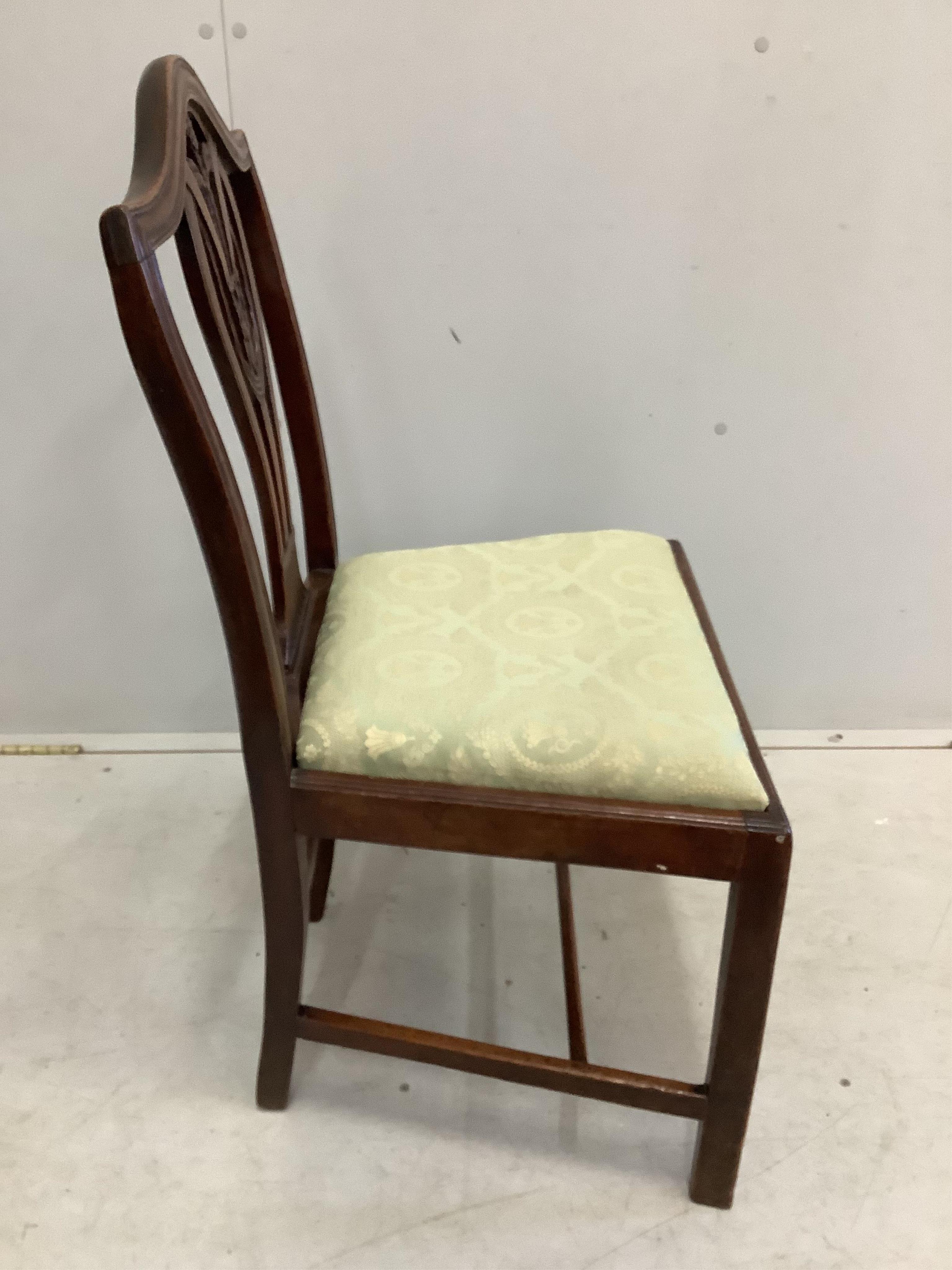 A George III circular mahogany tilt top tripod tea table, diameter 99cm, height 75cm together with four George III mahogany dining chairs. Condition - fair